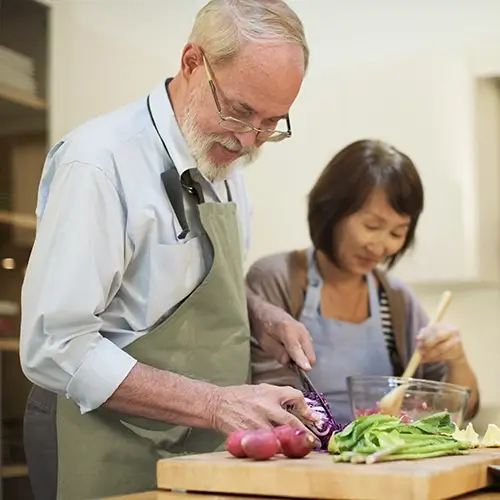 Senior couple preparing healthy meal together representing Medi-Cal Regulation Specialists supporting seniors with healthcare and nutritional planning