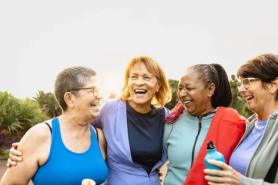 Four smiling and laughin senior ladies outdoor to show the age groups Medi-Cal Regulation Specialists specialize in which are seniors living in California and in need of Medi-Cal