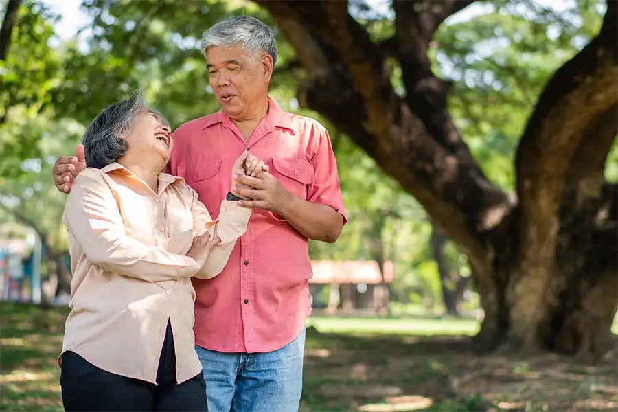 Smiling senior couple with a healthcare professional, representing Medi-Cal services for seniors, including long-term care, in-home support, and medical benefits assistance.